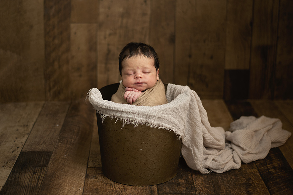 newborn in a bucket